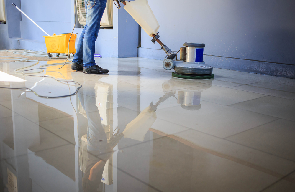 Semper fi team member’s cleaning floor with machine.